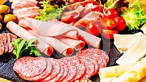 Assortment of salami prosciutto meats and sausages, olives and spices.Meat appetizer.Different types of sausages with