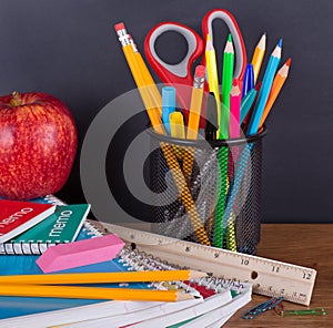 Assortment of School Suppies with Chalkboard Background