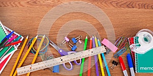 Assortment of School Suppies on a Wooden Background
