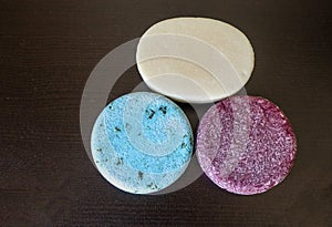 Assortment of Shampoo Bars and Conditioner bars on a dark table background
