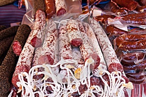Assortment of Spanish meat sausages salchichon, fuet, chorizo for sale at Sineu market, Majorca