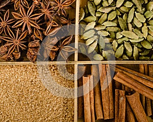 Assortment of spices in the box: star anise, cardamom, brown sugar, cinnamon sticks