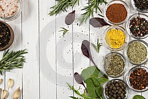 Assortment of spices and herbs on white wooden background. Top view