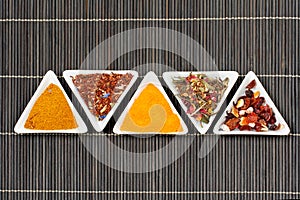 Assortment of spices over a bamboo mat