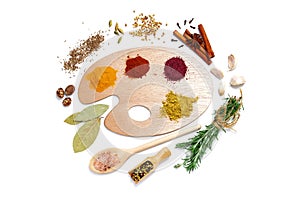 Assortment of spices on a polish for artist paints, on a white background, top view, horizontal, no peope