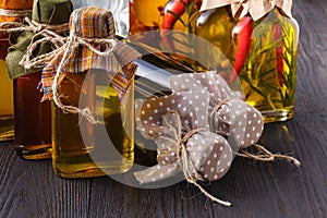 Assortment of spicy oils with herbs and spices in different bottles