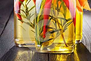 Assortment of spicy oils with herbs and spices in different bottles