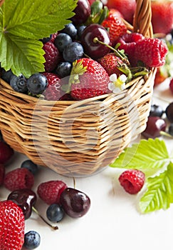 Assortment of summer berries in the basket.