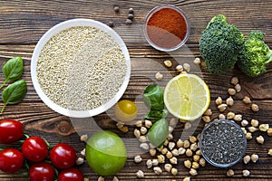 Assortment of superfood seeds and vegetables on wooden background. Vegetarian or vegan concept