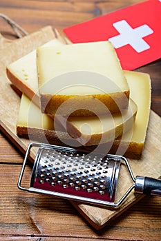 Assortment of Swiss cheeses Emmental or Emmentaler medium-hard cheese with round holes, Gruyere, appenzeller and raclette used for