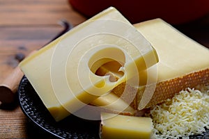 Assortment of Swiss cheeses Emmental or Emmentaler medium-hard cheese with round holes, Gruyere, appenzeller and raclette used for