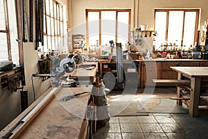 Assortment of tools on workbenches in a woodworking shop