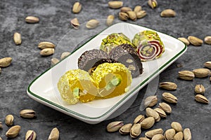 Assortment of Turkish delight with pistachio on a dark background.