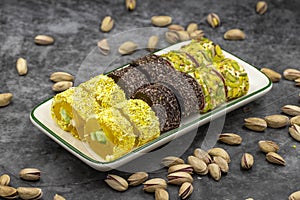 Assortment of Turkish delight with pistachio on a dark background.