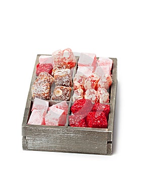 Assortment turkish delight in wooden box isolated on white