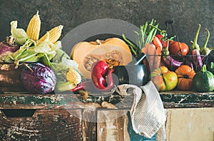 Assortment of various Fall vegetables for cooking on rustic cupboard