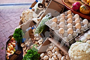 An assortment of vegetables and fresh produce eggs at a farmers market