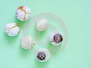 Assortment of white comfit and sweets in green background for dessert