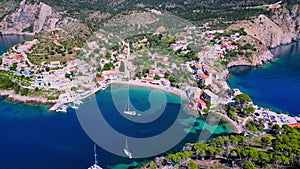 Assos, Greece. Aerial drone flight over picturesque village nestled on the idyllic Kefalonia, Greek Islands.