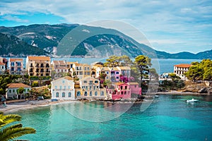 Assos village. Beautiful view to vivid colorful houses near blue turquoise colored transparent bay lagoon. Kefalonia photo