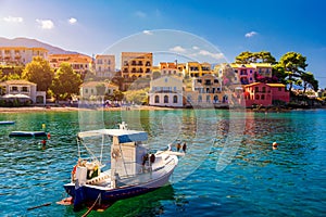 Assos village in Kefalonia, Greece. Turquoise colored bay in Mediterranean sea with beautiful colorful houses in Assos village in