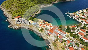 Assos village in Kefalonia, Greece. Turquoise colored bay in Mediterranean sea with beautiful colorful houses in Assos village in