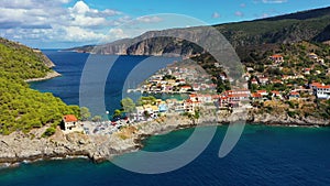 Assos village in Kefalonia, Greece. Turquoise colored bay in Mediterranean sea with beautiful colorful houses in Assos village in