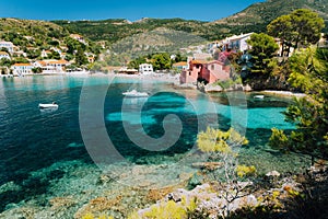 Assos village, Kefalonia Greece. View to cute bay with vivid colored houses and transparent turquoise water surrounded