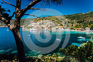 Assos village, Kefalonia Greece. View on turquoise transparent bay lagoon of Mediterranean sea. Surrounded by green pine