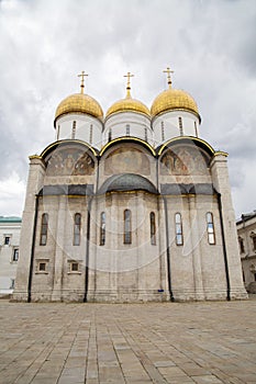 Assumption Cathedral in the Kremlin against the background of white clouds on a clear sunny day, Moscow. Sights of Russia