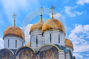 Assumption Cathedral of the Kremlin, domes against the backdrop of the sun and summer sky - Kremlin, Moscow, Russia in June 2019