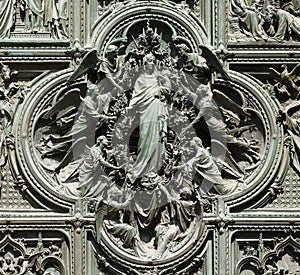 Assumption of the Virgin Mary, detail of the main bronze door of the Milan Cathedral photo