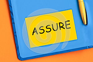 Assure the word is written in black letters on the yellow paper for notes photo