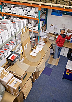 Assuring quality on the shop floor. High angle shot of a worker in a distribution warehouse.