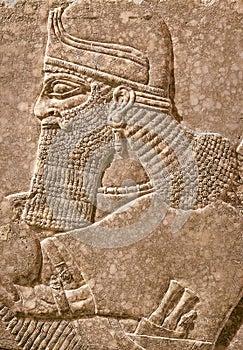 Assyrian wall relief of a genius from Mesopotamia, detail with a head photo