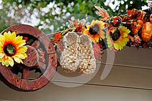 Ast shoes, sunflowers and wheel as autumn decoration for street festival `Moscow autumn`