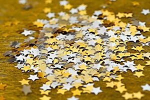 Asterisks shiny Christmas scattered on a gold background