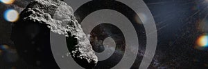 Asteroid in empty space lit by the Sun, banner format background