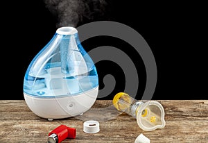 Asthma, allergy airway problem, pulmonary disorders concept with ultrasonic tabletop humidifier creating steam.