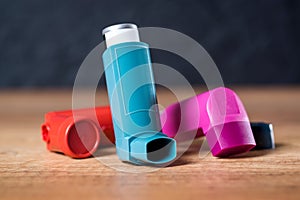 Asthma inhalers on a wooden table