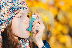 Asthma patient girl inhaling medication for treating shortness o
