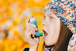 Asthma patient girl inhaling medication for treating shortness o photo
