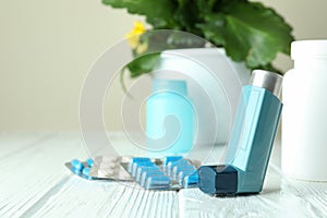 Asthma treatment accessories on white wooden table