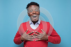 Astonished afro american guy being surprised receiving compliment.