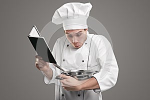 Astonished apprentice trying to cook dish