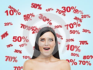 Astonished brunette surrounded by discount and sale numbers: 10% 20% 30% 50% 70%.