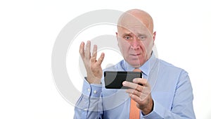 Astonished businessman read bad news on mobile and gesticulate nervous