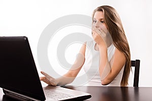 Astonished girl behind a laptop