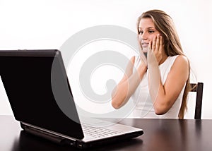 Astonished girl behind a laptop