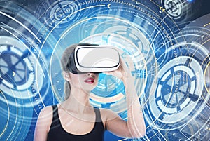 Astonished girl in VR glasses futuristic interface